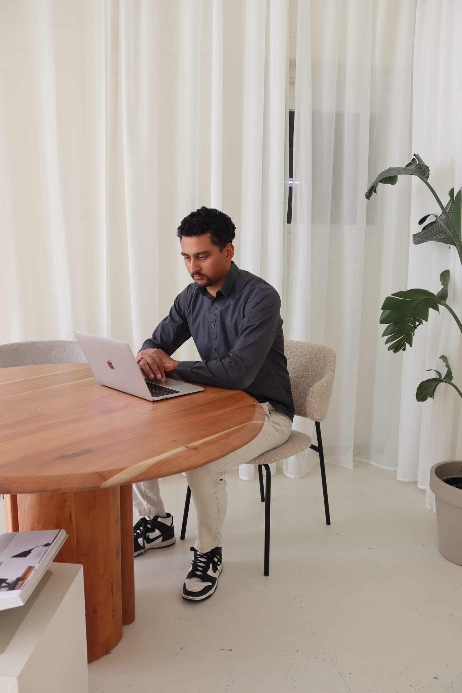 A workspace at the long wooden table in the We Got It Marketing office