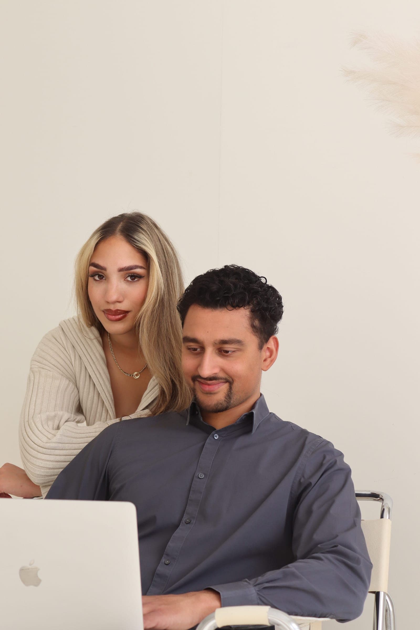 Two colleagues looking at one screen together